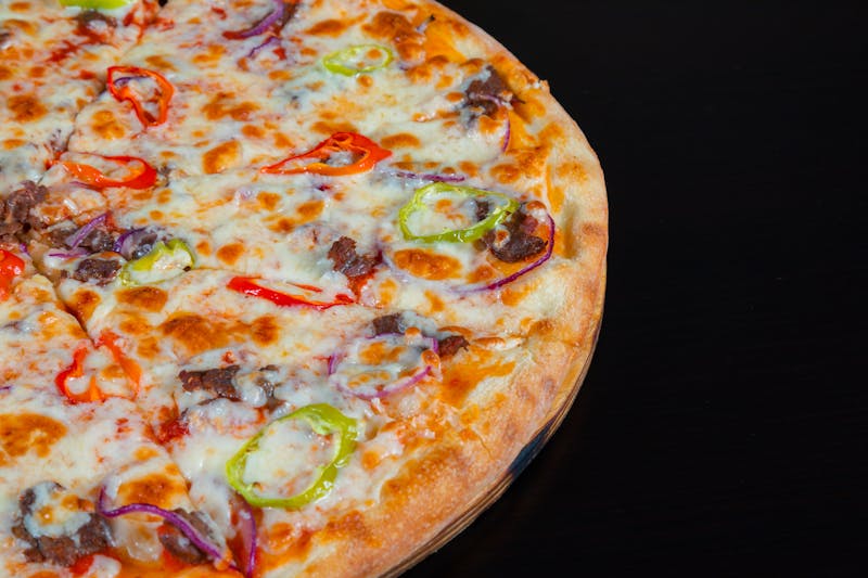 Supreme pizza with bell peppers, mushrooms and olives