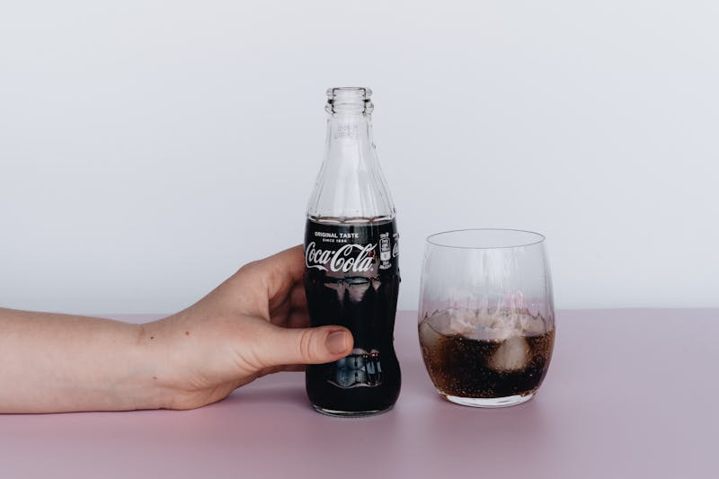 Classic cola soft drink in a glass with ice